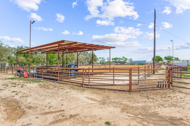 view of horse barn with a rural view