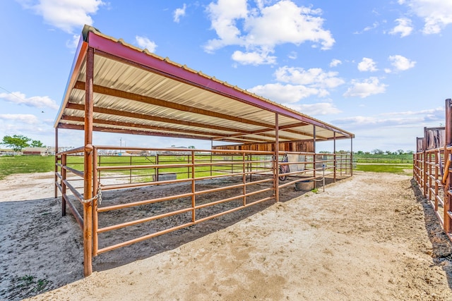 view of horse barn featuring a rural view