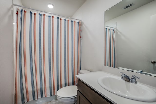 bathroom featuring vanity, toilet, and a shower with curtain