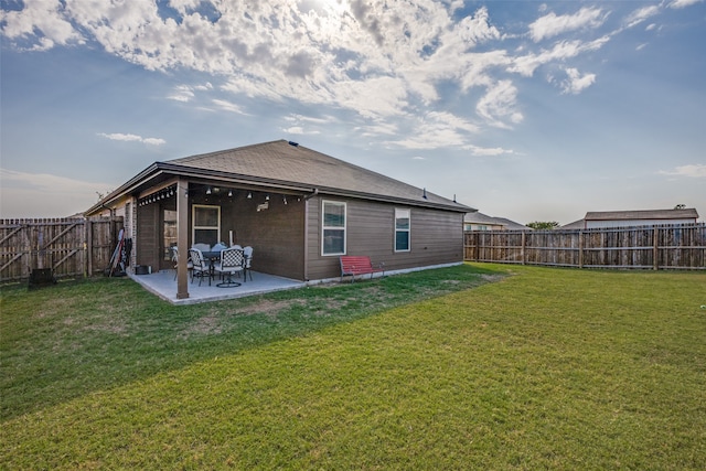 back of property featuring a patio and a lawn