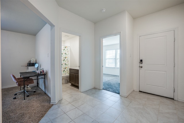 entrance foyer featuring light colored carpet