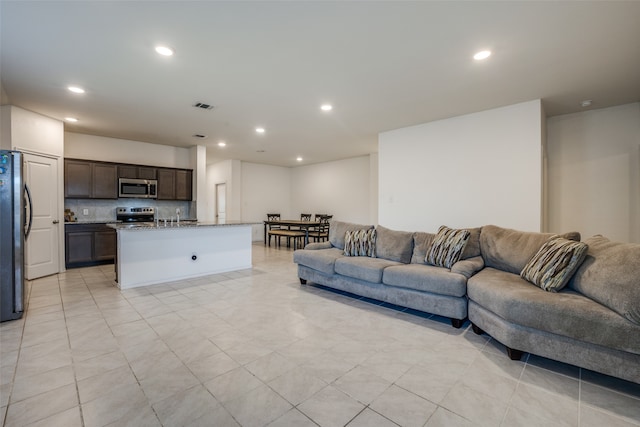 living room with sink and light tile patterned floors