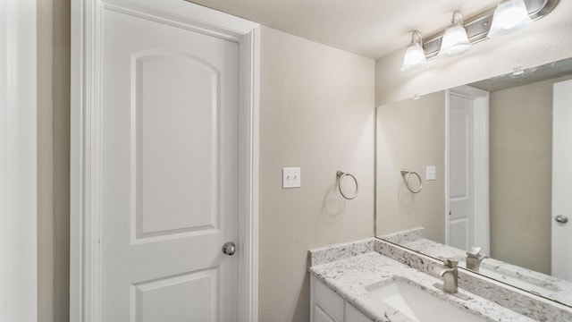 bathroom with vanity and a textured ceiling