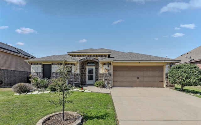 prairie-style home featuring a garage and a front lawn