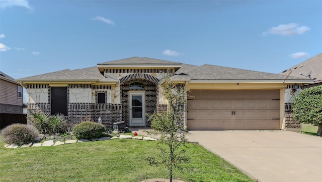 view of front facade with a garage and a front lawn