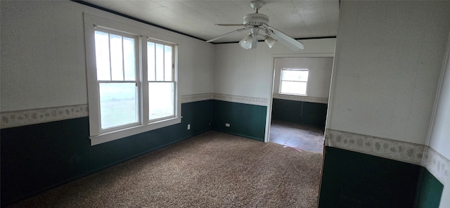 carpeted empty room featuring ceiling fan