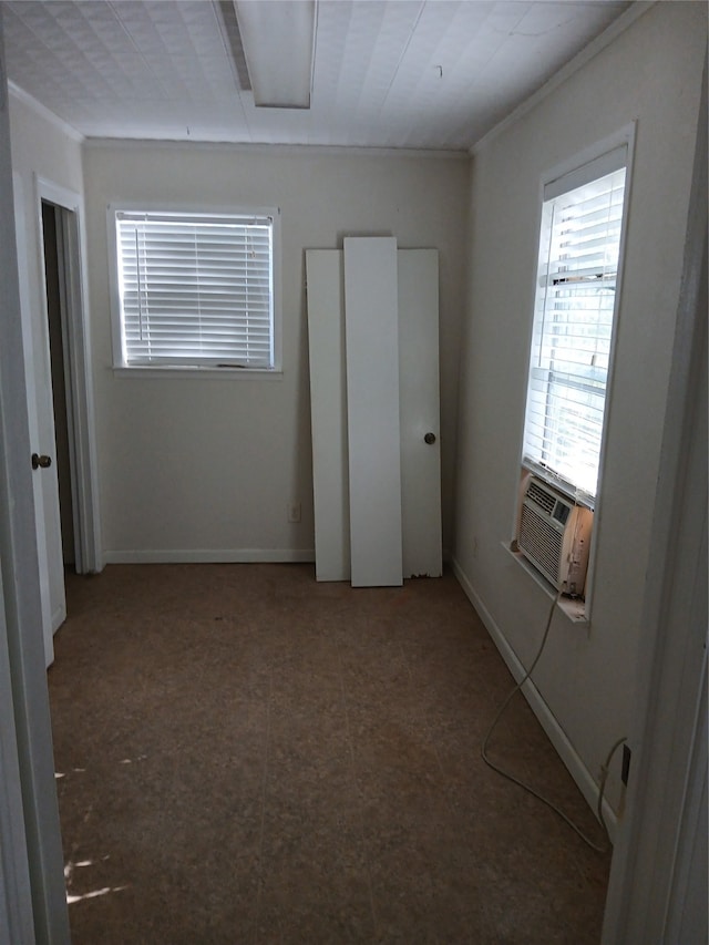 unfurnished bedroom with cooling unit and ornamental molding