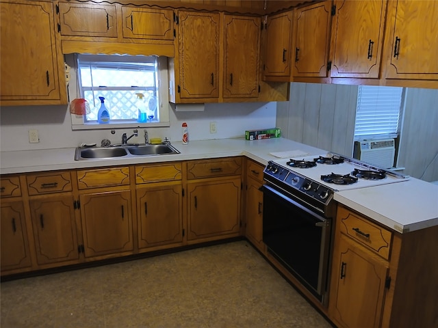 kitchen featuring cooling unit, kitchen peninsula, sink, and range