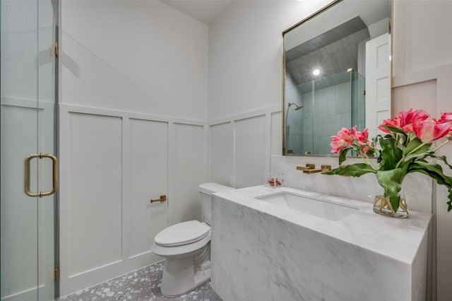 bathroom featuring tile patterned floors, vanity, a shower with door, and toilet