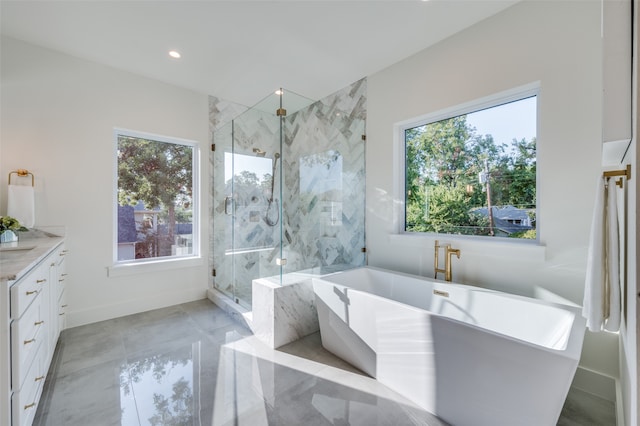 bathroom featuring a wealth of natural light, vanity, and shower with separate bathtub