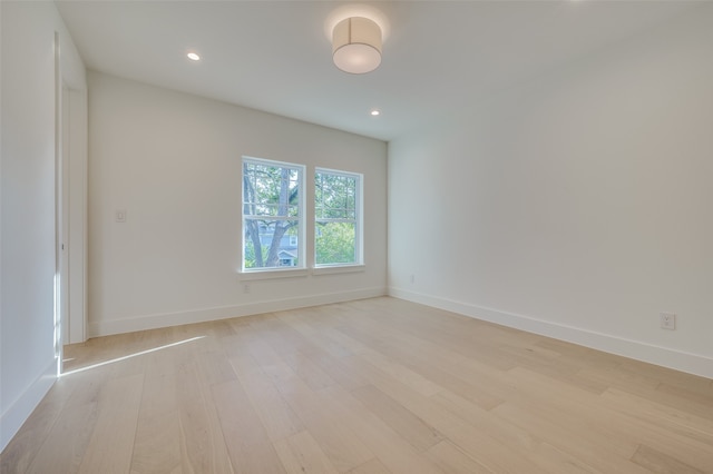 spare room with light hardwood / wood-style flooring