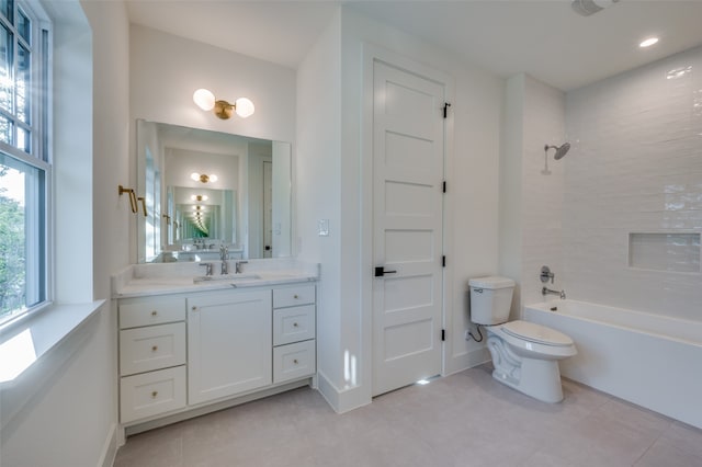 full bathroom featuring tile patterned floors, vanity, toilet, and tiled shower / bath combo