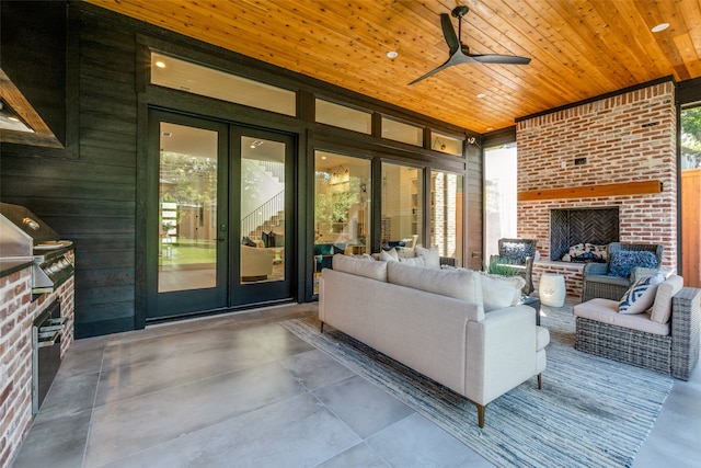 living room featuring ceiling fan, wood ceiling, concrete floors, a brick fireplace, and wooden walls