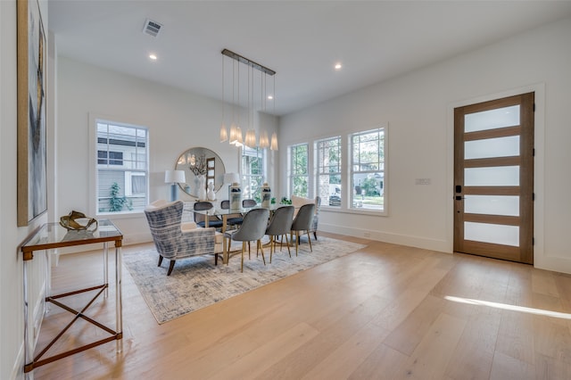 dining space with an inviting chandelier and light wood-type flooring