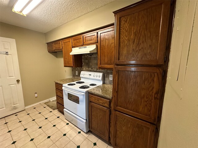 kitchen featuring decorative backsplash, electric range, a textured ceiling, and dark stone countertops