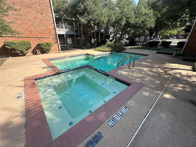 view of pool with a community hot tub