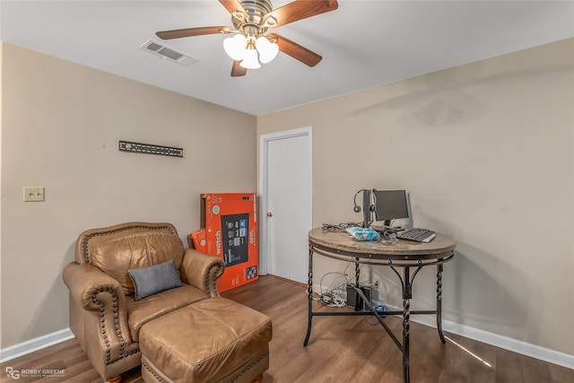 living area featuring hardwood / wood-style floors and ceiling fan