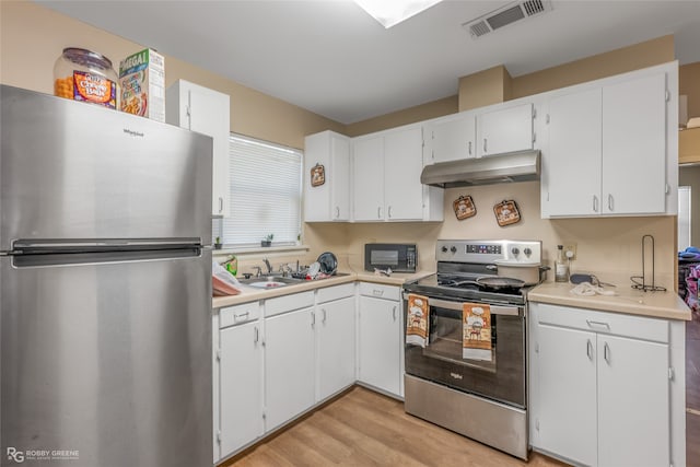 kitchen with light wood-type flooring, sink, stainless steel appliances, and white cabinets