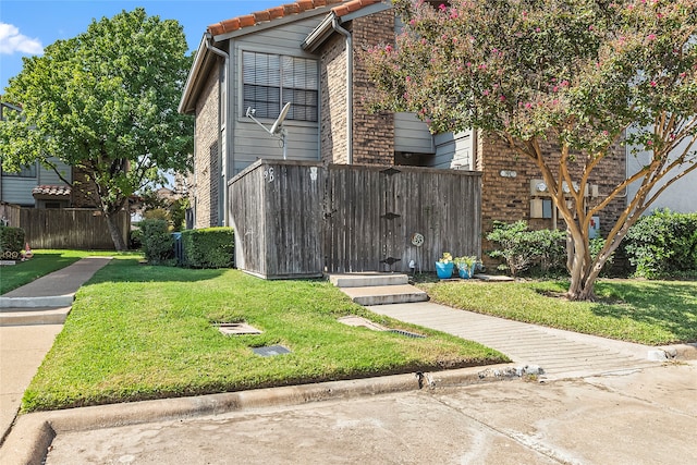 view of side of property with a lawn