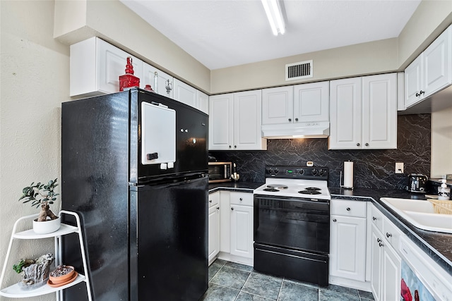 kitchen featuring decorative backsplash, white appliances, dark tile patterned floors, and white cabinetry