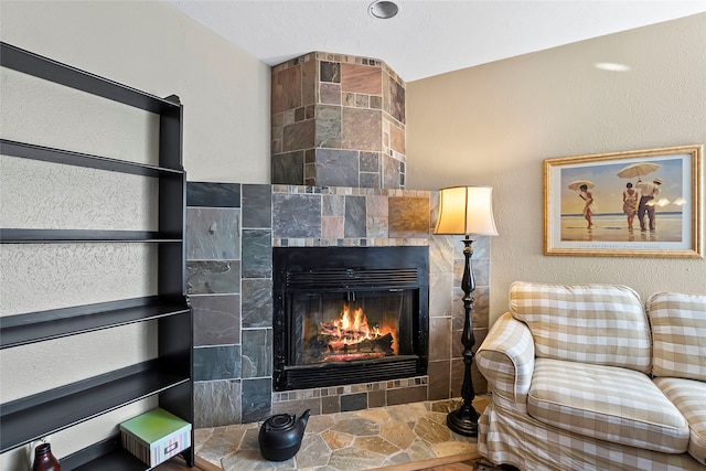 living room with a tiled fireplace