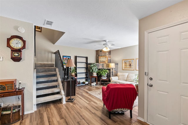 foyer entrance featuring hardwood / wood-style floors, a textured ceiling, and ceiling fan