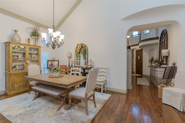 dining area featuring high vaulted ceiling, dark hardwood / wood-style floors, and a chandelier