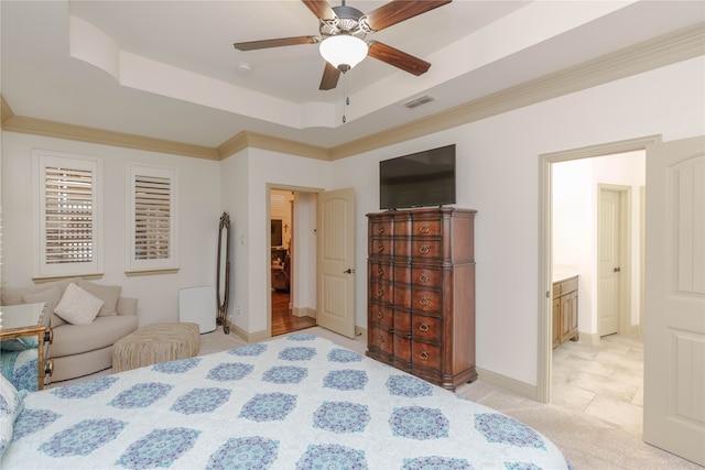 bedroom featuring ornamental molding, light carpet, a raised ceiling, ceiling fan, and ensuite bathroom