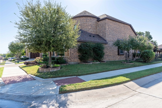 view of side of property with a lawn