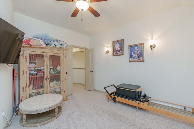 sitting room featuring ceiling fan and carpet