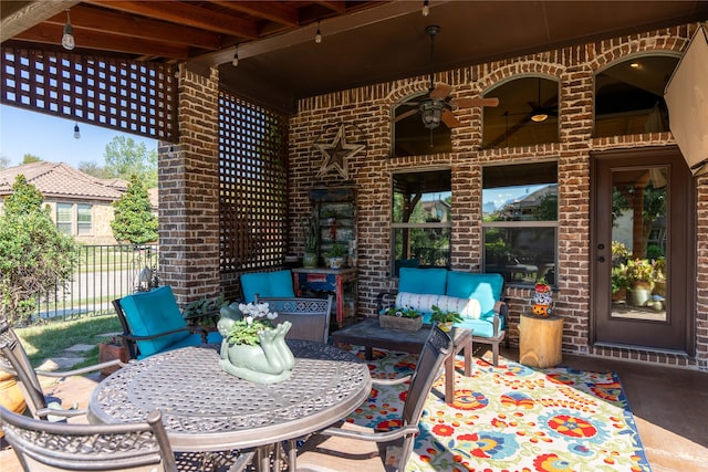 view of patio / terrace with ceiling fan and an outdoor living space