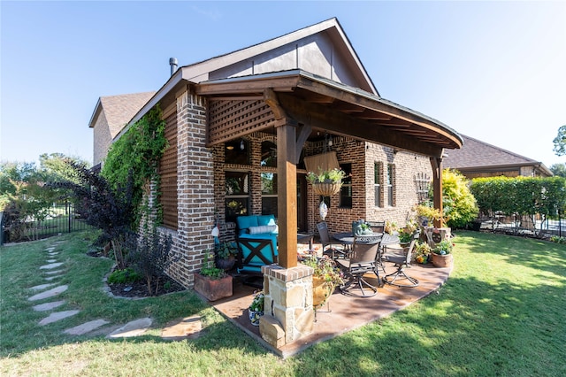 back of house featuring a yard and a patio area