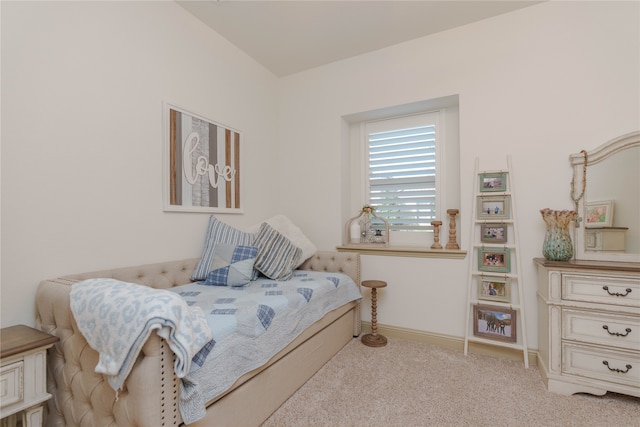 bedroom featuring light colored carpet