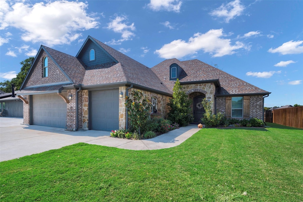 view of front of home with a front lawn and a garage