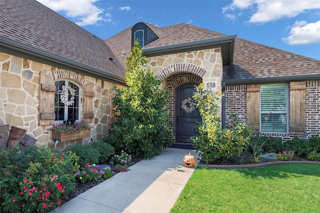 doorway to property with a yard