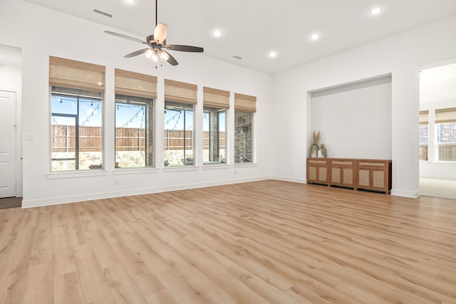 spare room with ceiling fan and light wood-type flooring