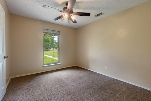 carpeted empty room with ceiling fan and a textured ceiling