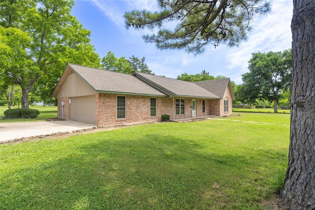 ranch-style home featuring a garage and a front lawn