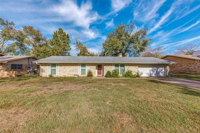 ranch-style home with an attached garage, a chimney, driveway, and a front yard
