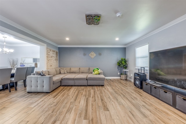 living room featuring light hardwood / wood-style floors, a chandelier, and ornamental molding