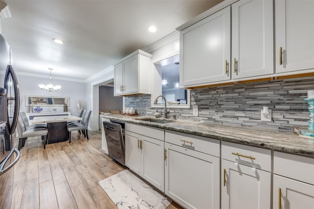 kitchen featuring crown molding, an inviting chandelier, stainless steel fridge, a sink, and dishwasher