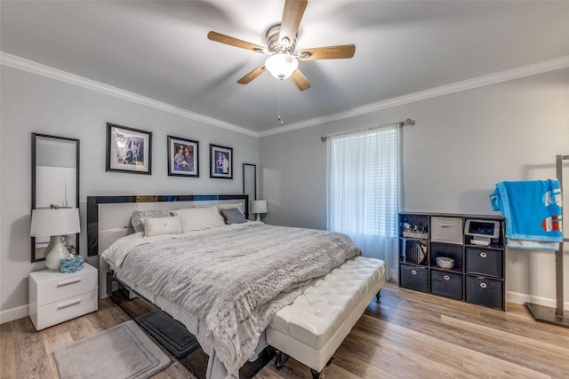 bedroom with baseboards, ornamental molding, a ceiling fan, and wood finished floors