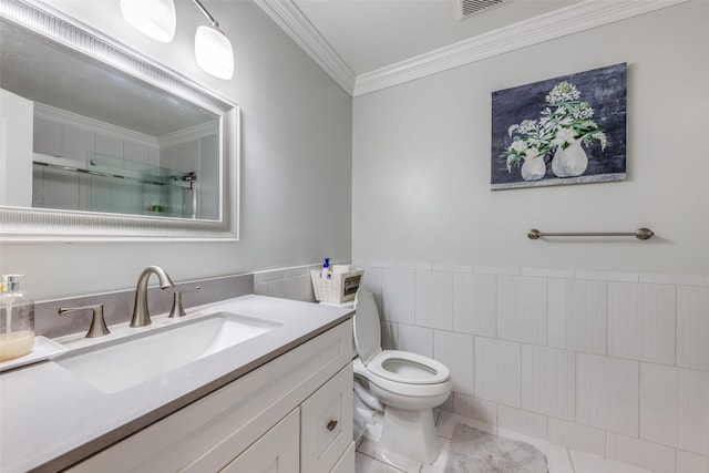 full bathroom featuring vanity, toilet, tile walls, a shower with door, and ornamental molding