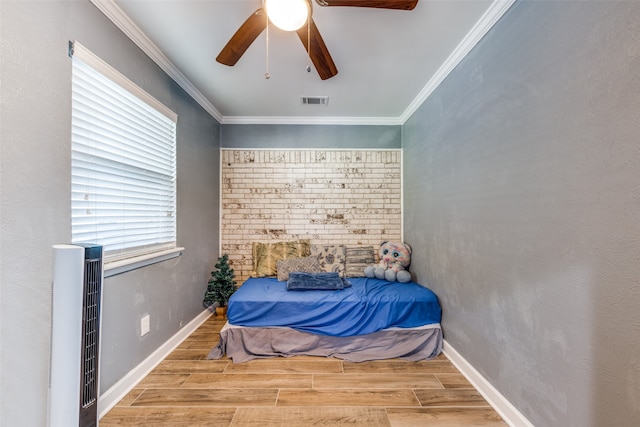 bedroom featuring ceiling fan, ornamental molding, and light hardwood / wood-style floors