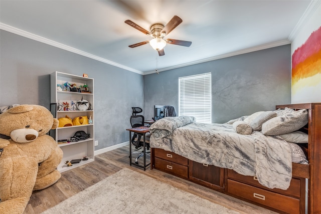 bedroom with ornamental molding, ceiling fan, and light hardwood / wood-style floors