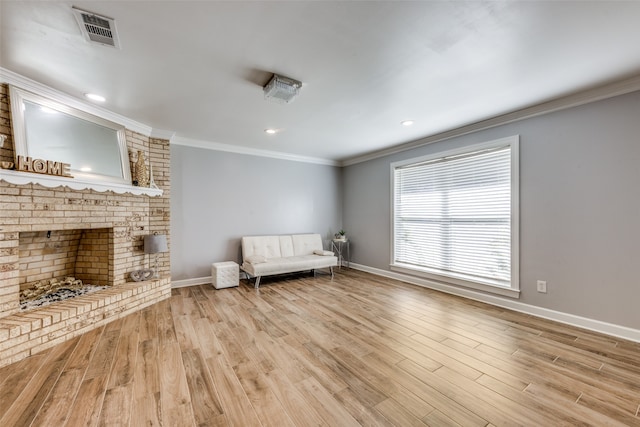 unfurnished room with light hardwood / wood-style flooring, a fireplace, and ornamental molding