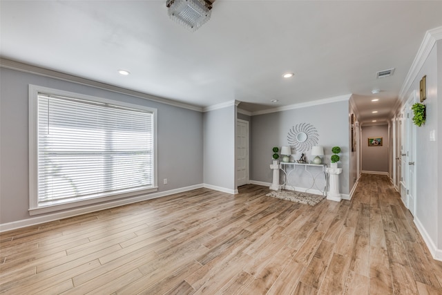 unfurnished living room with ornamental molding and light hardwood / wood-style flooring