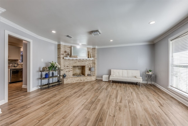 unfurnished room featuring a brick fireplace, crown molding, and light wood-type flooring