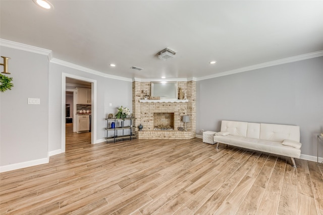 living room featuring recessed lighting, ornamental molding, and light wood-type flooring