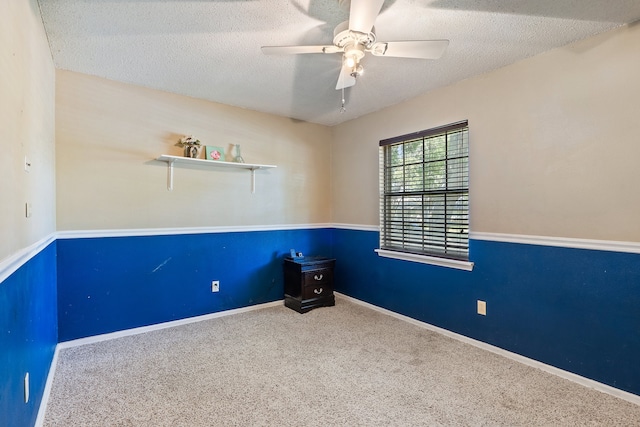 empty room featuring carpet flooring, ceiling fan, and a textured ceiling